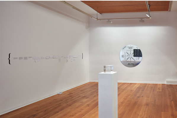 Identification Please, Liz Magic Laser, 2016, newspaper and video installation, installation view with&amp;nbsp;The Invisible Cube, 2013, etched crystal, 4 x 4 x 4 in., edition of 5 and&amp;nbsp;Inflective Medallion, 2015, enamel silkscreened on mirror,&amp;nbsp;47 x 47 x 0.25 in., Kunstverein G&amp;ouml;ttingen, Germany.